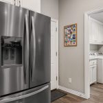 Separate laundry room off of kitchen.