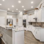 The large kitchen offers abundant counter space, a sitting bar, convenient dining area, and pantry.