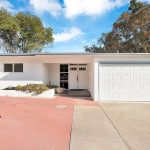 Exterior front shot of a modern white home on a quite street in Monterey Park