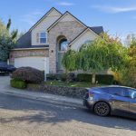 16228 SW Cooper Ln Tigard OR, street view of the brick-front two-story home and driveway