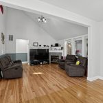Living room at 16228 SW Cooper Ln Tigard with vaulted ceiling, oak hardwood floors and gas fireplace