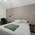 Main-floor primary bedroom with vaulted ceiling at 16228 SW Cooper Ln Tigard OR