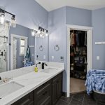 Main-floor primary bathroom at 16228 SW Cooper Ln Tigard with tiled walk-in shower and dual-sink quartz vanity